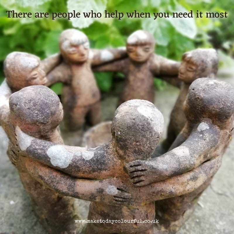 Photo of a garden ornament of people linking arms in a circle.